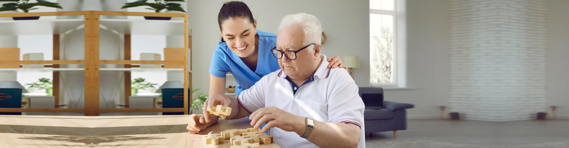 senior man with caregiver playing puzzle